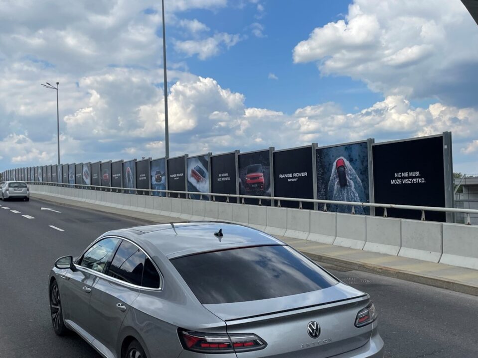 Kilkudziesięciometrowa reklama Range Rovera Sport na estakadzie dojazdowej do lotniska Chopina